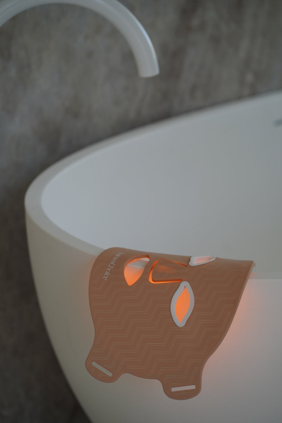 NursesChoice LED face mask lit and resting over the edge of a bath, stocked at The Glow Co. Aesthetics Gordon Park Brisbane