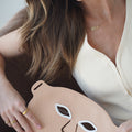 Woman holding the NursesChoice LED face mask, showing the eye openings and silicone finish
